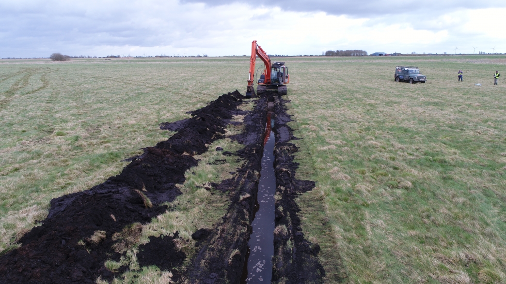 Excavating a drainage ditch